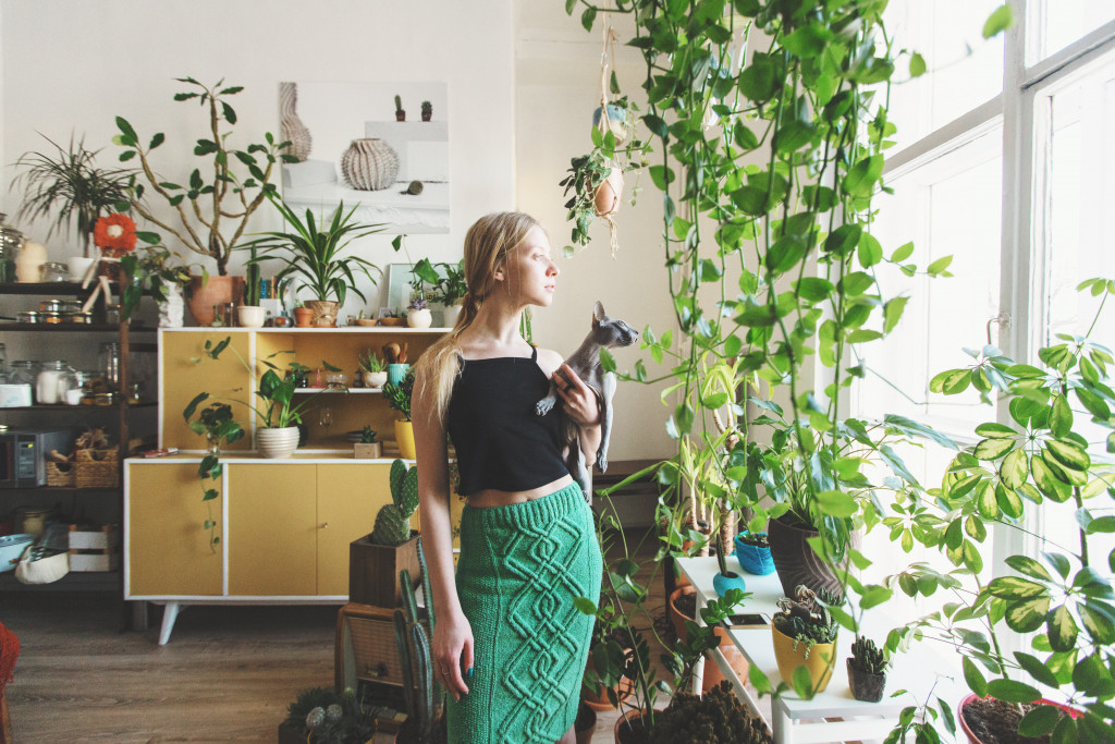 woman inside house with plants