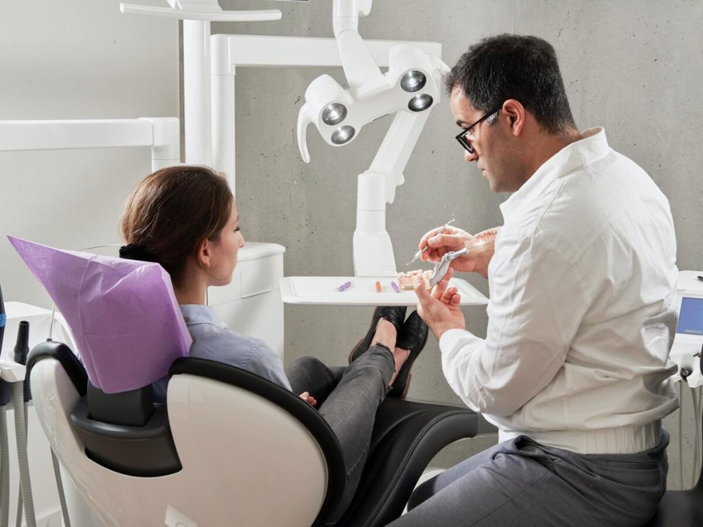 consulting dentist in cleaning teeth