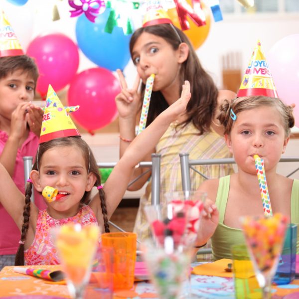 Children wearing party hats at a birthday party