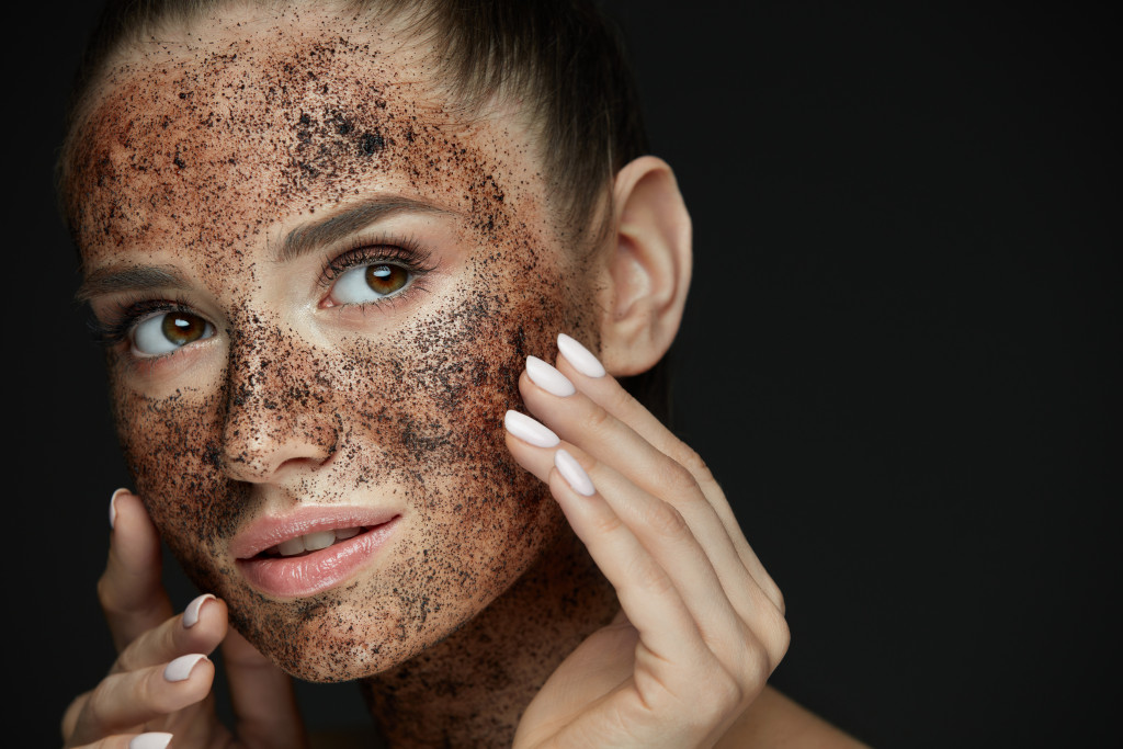 A woman exfoliating her skin