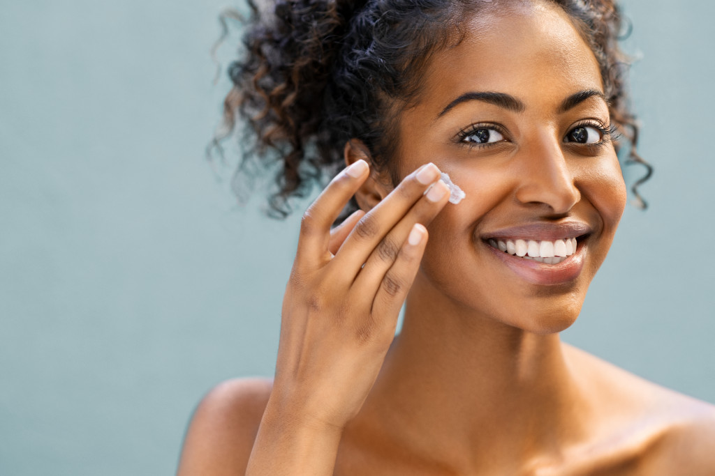 applying cream on face